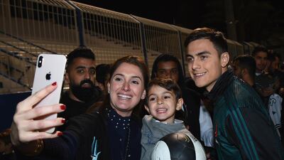 Paulo Dybala of Juventus signing autographs and taking selfies. Getty