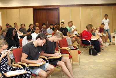 Personal finance enthusiasts listen to a talk on financial independence by John van Zuylen. Anna Nielsen / The National.