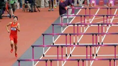 China's Xiang Liu hopped to the finish line after he crashed into the first hurdle in the heats for the men's 110m Hurdles.