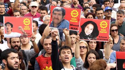 Turkish Labour Party activists at the demonstration in Ankara yesterday with images of party members who were victims of the terrorist attack. Adem Altan / AFP