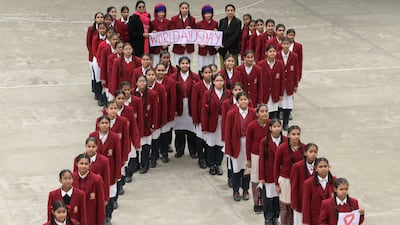 Schoolchildren in Amritsar, India, line up to represent a ribbon on the eve of World Aids Day. AFP