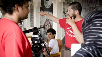 Heinz Kahler, left, Tariq Ibrahim, center, Mohammad Khawaja, right, students of The New York Film Academy make a short film for class. Lauren Lancaster / The National.