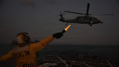 A US technician directs an MH-60S Sea Hawk helicopter in the Arabian Gulf last week. AFP