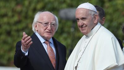Pope Francis stands by Irish President Michael D Higgins at Aras an Uachtarain in Phoenix Park. PA via AP