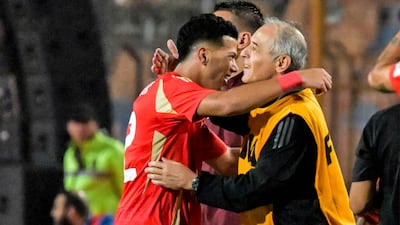 Al Ahly's Emam Ashour celebrates with manager Marcel Koller after scoring his team's second goal. AFP