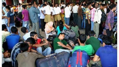 Indian minority north-eastern residents wait at a train platform as they prepare to leave the city following rumours of communal violence against them, at a railway station in Bangalore on August 16, 2012. Thousands of Indians from the northeast of the country have fled southern cities after rumours they would be attacked by Muslims in reprisal for recent ethnic violence, officials said August 16. AFP PHOTO/Manjunath KIRAN