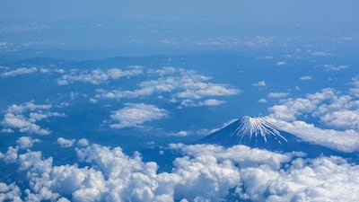 Mount Fuji, Japan's highest peak at 3,776 metres, noses through the clouds above Shizuoka Prefecture. AFP