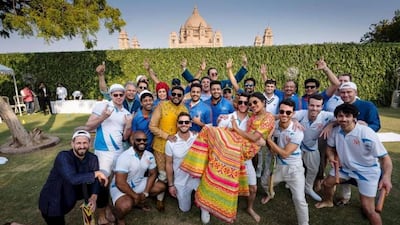 Priyanka Chopra is lifted by Nick Jonas as they pose for a photograph with others after a cricket match, a day before their wedding, at Umaid Bhawan in Jodhpur, India. Photo: Raindrop Media via AP