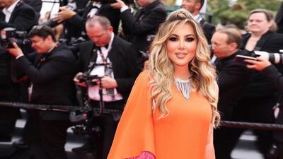Reem Abou Samra wore a crepe kaftan in burnt orange, trimmed with feathers. Photo: Rami Al Ali