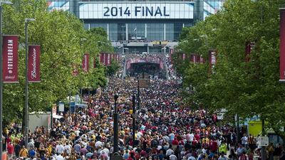 Football fans arrive ahead of the FA Cup final between Arsenal and Hull City on Saturday at Wembley Stadium in London. Will Oliver / AFP / May 17, 2014