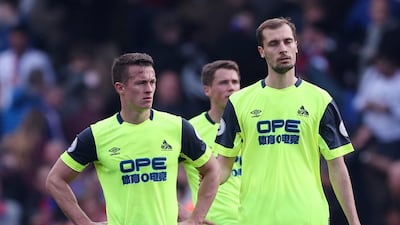 Huddersfield Town's Jon Gorenc Stankovic and team mates look dejected after the match. Reuters