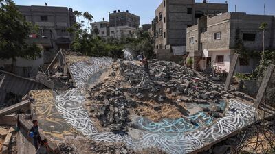Palestinian artist Ayman Alhossary, 35, finishes artwork on the ruins of a house in Beit Lahia destroyed by Israeli air strikes during the May 2023 conflict in the Gaza Strip. AFP