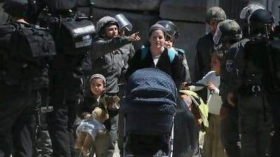 Israeli forces evict a group of settlers from a disputed house in Hebron.