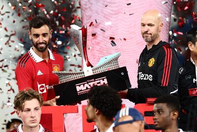 Manchester United manager Erik Ten Hag and Bruno Fernandes hold the Bangkok Century Cup. AFP