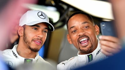 Mercedes-GP driver driver Lewis Hamilton, left, poses for a selfie with Hollywood actor Will Smith before Sunday's Abu Dhabi Grand Prix at Yas Marina Circuit. Hamilton went on to win the race. AFP