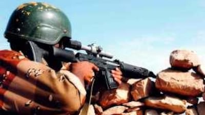 A government soldier takes aim at an al Houthi rebel target as the military continues its operation Scorched Earth offensive in Sa'ada province.