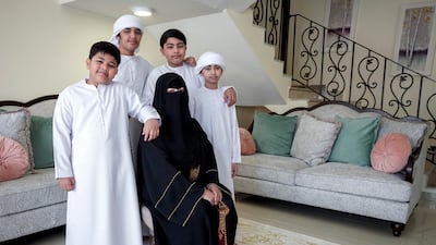 Mona Mohamed Baraguir donates rice, eggs, cooking oil and other daily essentials to laid off workers. Seen here with her children, (L-R) Fares, 9, Hamed Khalifa,15, Ali,13 and Saed, 11, Abu Dhabi, April 30. Victor Besa / The National
