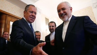 Russian Foreign Minister Sergei Lavrov (L) and his Iranian counterpart, Mohammad Javad Zarif, smile during their meeting in Moscow on May 14, 2018. Maxim Shemetov / AFP