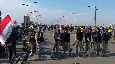 Iraqi anti-riot police stand guard while anti-government protesters gather for a demonstration in Baghdad on Friday. AP