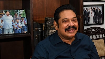 Prime Minister Mahinda Rajapaksa poses for photographs at his home in the southern town of Tangalle on August 7, 2020, after the Sri Lanka's parliamentary election results. AFP