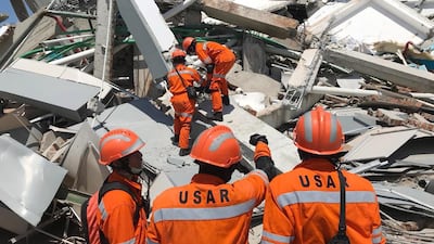 Indonesian rescuers work on the collapsed Roa Roa hotel. EPA