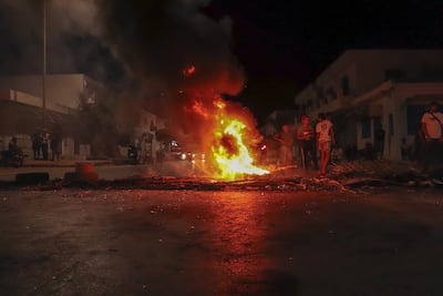 Demonstrators block a road with burning tyres in Zarzis. Ghaya Ben Mbarek for The National