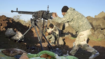 Rebel fighters of the southern front of the Free Syrian Army take positions as one of them aims his weapon at the front line in the north-west countryside of Deraa on March 3, 2015. Reuters