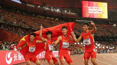 Su Bingtian, second right, with teammates Xie Zhenye, Zhang Peimeng and Mo Youxue of China shown after their silver-medal run in the 4x100m relay at the world championships on Saturday. Andy Lyons / Getty Images / August 29, 2015
