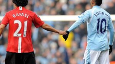 Manchester United's Rafael, left, keeps City's Robinho at arms length in this season's first Manchester derby, which United won 1-0.