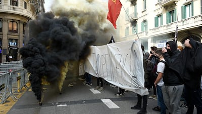 TOPSHOT - Protesters ignite smoke grenades during a student demonstration. AFP