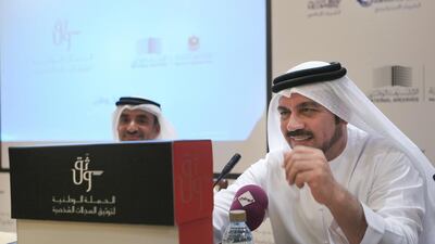 Dr. Abdulla al Rayess (R) director general of the National Archives, showing the box in which Emirati families can archive their historical documents (Ravindranath K / The National)