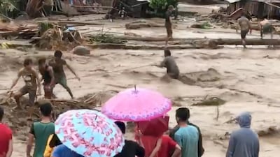 People help rescue flood victims in Lanao Del Norte, Philippines, December 22, 2017 in this image taken from video footage obtained from social media. Climah Cabugatan Disumala / Reuters