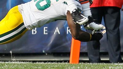Chicago Bears wide receiver Johnny Knox (13) catches a pass and is tackled by Green Bay Packers defensive back Charlie Peprah (26) in the first half of an NFL football game in Chicago, Sunday, Sept. 25, 2011. (AP Photo/Charles Rex Arbogast) *** Local Caption *** Packers Bears Football.JPEG-02df9.jpg