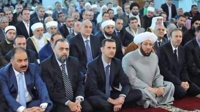 Syria's President Bashar Al Assad (centre) attends Eid Al Fitr prayers at Anas bin Malek mosque in Damascus.