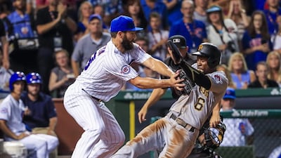 Chicago Cubs pitcher Jake Arrieta (left) tags out Pittsburgh Pirates outfielder Starling Marte of the Dominican Republic at home plate on a run down in the fifth inning of the MLB baseball game between the Pittsburgh Pirates and the Chicago Cubs at Wrigley Field in Chicago, Illinois. EPA