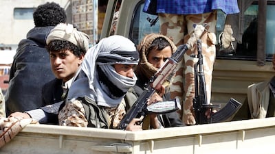 Houthi fighters ride in the back of a truck in Sanaa on December 4, 2017. Yahya Arhab / EPA