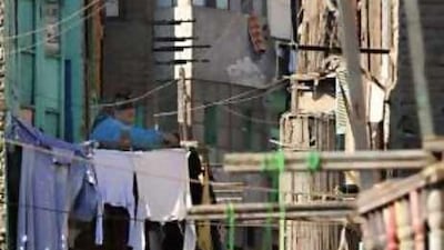 A woman hangs laundry in the low-income Boulaq neighbourhood of Cairo