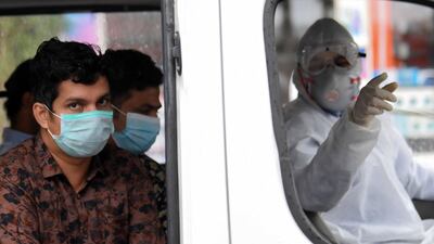 Foreign workers who have tested positive for Covid-19 are transported to a centre for isolation and treatment. AFP / KARIM SAHIB