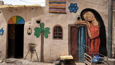 A girl sleeps on a door frame in this mural