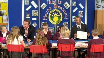 The British prime minister David Cameron, left, and US president Barack Obama speak to pupils during a visit to a primary school in Newport, South Wales, on September 4, 2014, prior to attending the two-day Nato summit being held there. Saul Loeb / AFP