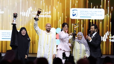 This year's winners, Samar Nadeem, Ahmed Zainoun and Khadija Al Qarti, show off their awards at Dubai's Coca-Cola Arena on Sunday. Chris Whiteoak / The National