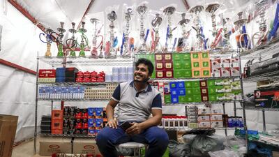 Mohammed Shaddad, from Bangladesh, runs a tobacco shop on Millions Street at the Al Dhafra Festival. Abu Dhabi, United Arab Emirates, December 10, 2019. Victor Besa / The National