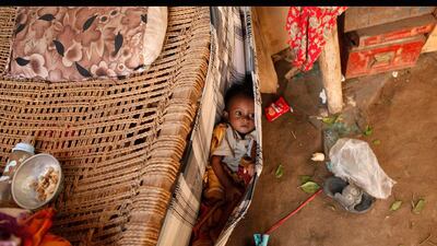 A boy lies in a baby hammock in his family's hut in the Akhdam community in Yemen's western port city of Houdieda.