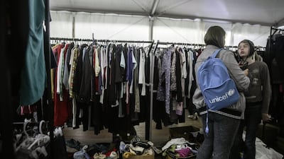 Visitors try on donated used clothes at a humanitarian aid hub for internally displaced people in Odesa, southern Ukraine. Bloomberg