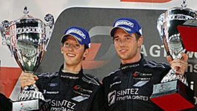Romain Grosjean, left, and Thomas Mutsch with the winners? trophies at Yas Marina Circuit in Abu Dhabi last night.