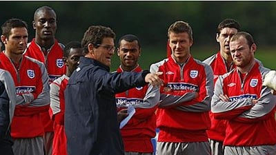 Fabio Capello, centre, talks to the England players during a training session in London Colney.