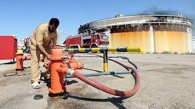 Smoke billows from an oil tank in Brega. EPA