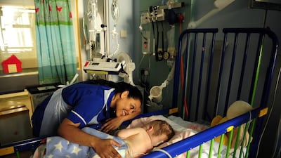 A nurse comforts a patient at the Great Ormond Street Hospital, the UK’s best-known children’s hospital. Dylan Martinez / Reuters