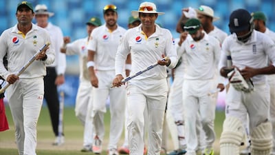 Pakistan's Younis Khan, left, and Misbah-ul-Haq, centre, leave the green after the Pakistan and England Test match at the Dubai International Stadium last year. Kamran Jebreili / AP Photo