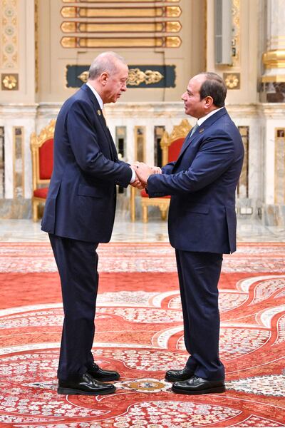 Turkey's President Recep Tayyip Erdogan, left, is welcomed by Egypt's President Abdel Fattah El Sisi during the D-8 summit. AFP